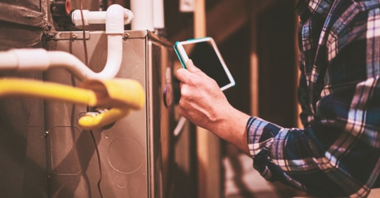 technician performing furnace service