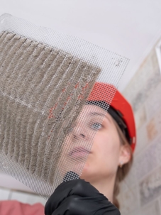 HVAC tech looking at dirty sheet